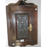 An early 20th century carved oak corner cupboard, 30" tall.