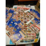 A box of 1983 and 1986 Matchbox toy catalogues and some product posters.