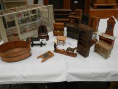 A mixed lot of dolls house furniture.