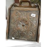 A 1920's ornately carved coal box with liner.