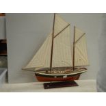 A model sailing boat, 30" long x 32" high.