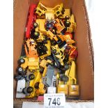A box containing various die cast dumper truck and truck models.