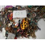 A very large collection of unsorted costume jewellery (crate not included)