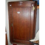 An old oak wall hanging corner cupboard.