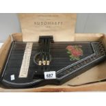 An original autoharp with instruction book.