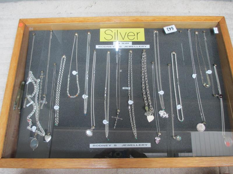 A display case of mainly silver pendants, chains etc., (this lot is buyer collect only).