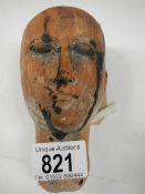 A Victorian carved wood dolls head.