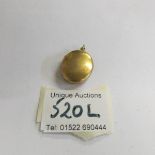 A 9.9 gram 18ct gold locket.
