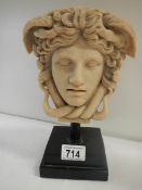 A resin half bust on plinth.