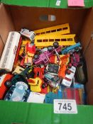 A box containing various die cast toys including Matchbox and Corgi.