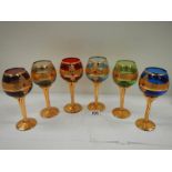 A set of 6 Bohemian coloured glasses with gilding (in good condition).