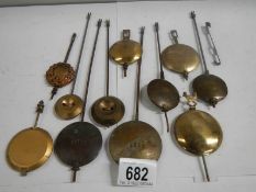 A mixed lot of old clock pendulums.