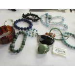 A mixed lot of stone pendants and bracelets.