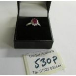 An 18ct gold ruby and diamond ring (Ruby 125, diamond 70pt) size M half.