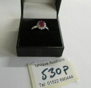 An 18ct gold ruby and diamond ring (Ruby 125, diamond 70pt) size M half.