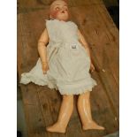 A Victorian porcelain headed doll, missing wig, 27".