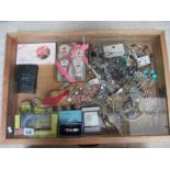 A display case containing a mixed lot of costume jewellery, boxed toiletries,