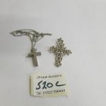 A silver cross on chain and a silver marcasite cross.