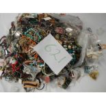 A very large collection of unsorted costume jewellery. (crate not included).