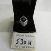 An 18ct onyx and diamond deco style ring in white gold, size N.