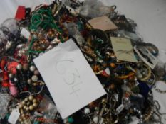 A very large collection of unsorted costume jewellery (crate not included)