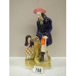 A Victorian Staffordshire figure of a farmer with a young girl.