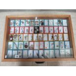 A display case containing in excess of 60 pieces of mainly silver pendants, rings, bracelets etc.