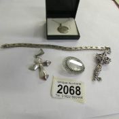 A collection of silver items: Italian bracelet, 2 crosses, brooch and St. Christopher.