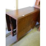 An oak cross stretcher drop leaf table.