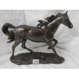 A bronzed resin horse, 16" long x 12" tall.