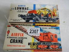 A boxed Airfix crane and a boxed excavator.