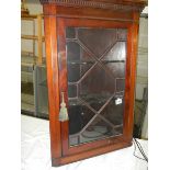 A mahogany astragal glazed hanging corner cabinet.