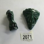 2 malachite stone paperweights as heads.