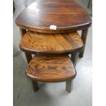 A nest of 3 heavy oak tables.