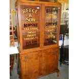 An Edwardian walnut veneered advertising display cabinet.