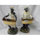 A pair of majolica style figures, 14.5" tall. Repairs to arms and basket on one figure.