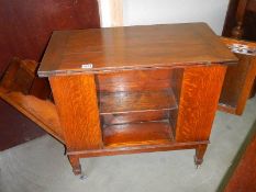 A fold over card table with pull down side and open door.