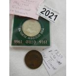 An Isle of Man halfpenny and an Irish commemorative coin.