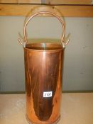 A 15" tall copper carrier with handle.