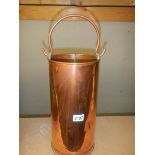 A 15" tall copper carrier with handle.