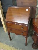 A slim mahogany bureau (handle missing).