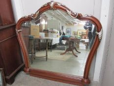 A large mahogany overmantel mirror.