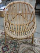 A wicker chair. ****Condition report**** For an adult. Solid condition.