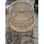 A wicker chair. ****Condition report**** For an adult. Solid condition.