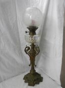 A Victorian brass oil lamp with cut glass font.