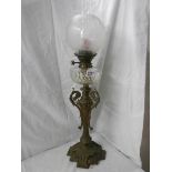 A Victorian brass oil lamp with cut glass font.