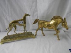 A Victorian brass greyhound doorstop and a brass horse.