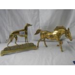 A Victorian brass greyhound doorstop and a brass horse.