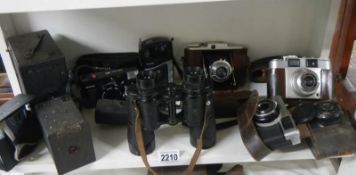 A pair of binoculars and a quantity of old camera's.