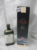 An unopened bottle of Arran malt whisky and an opened bottle of Gordon's gin.